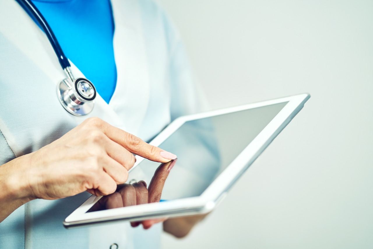 Nurse uses tablet to review patient notes